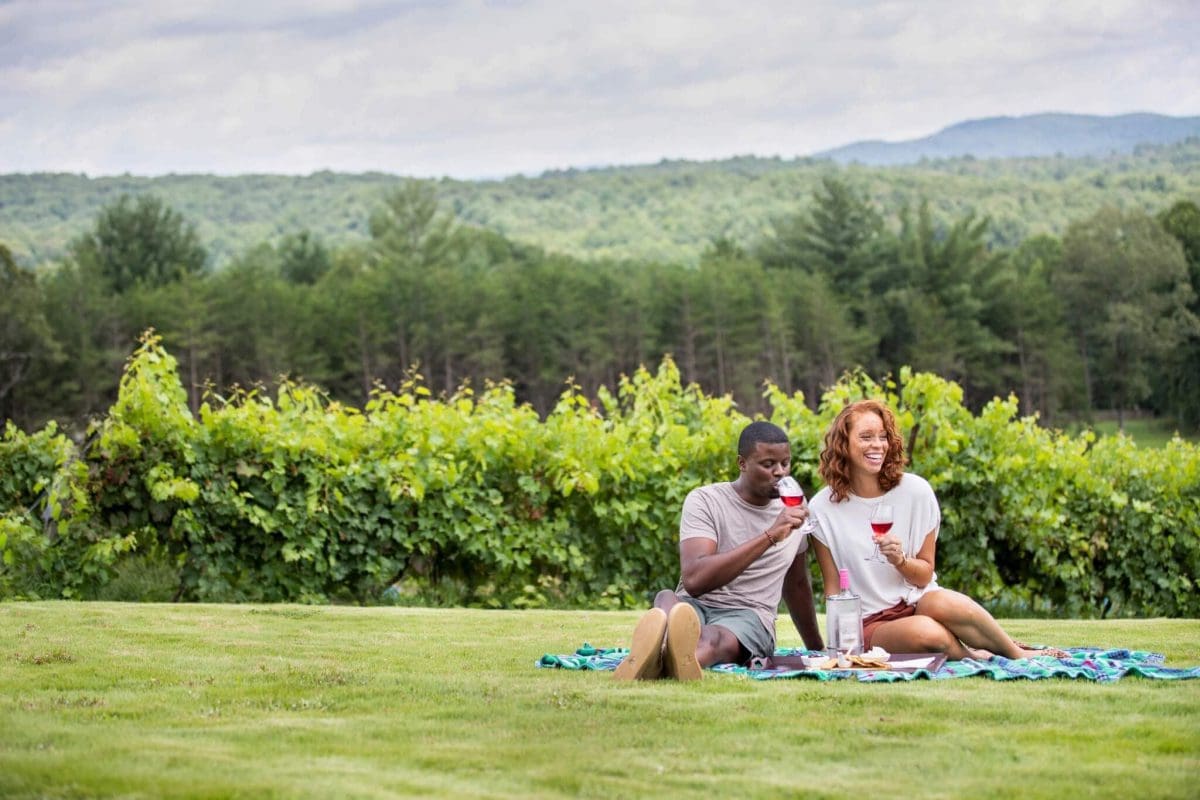 A couple having a picnic and enjoying wine