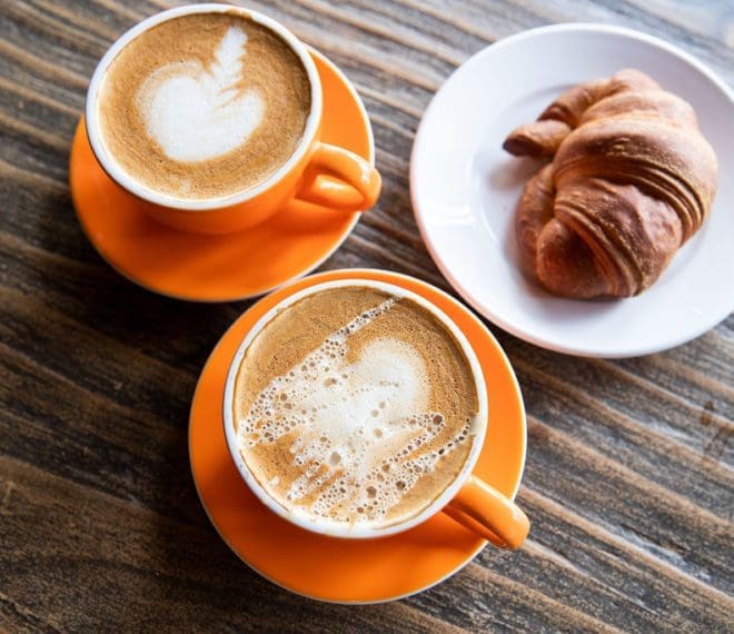 mugs of coffee and a pastry