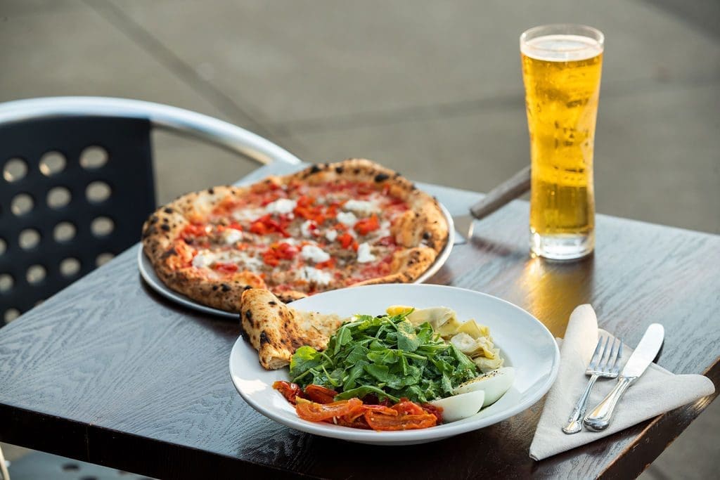 a pizza, beer, and a salad
