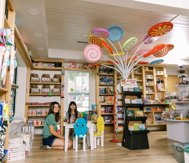 children at a small table surrounded by candy