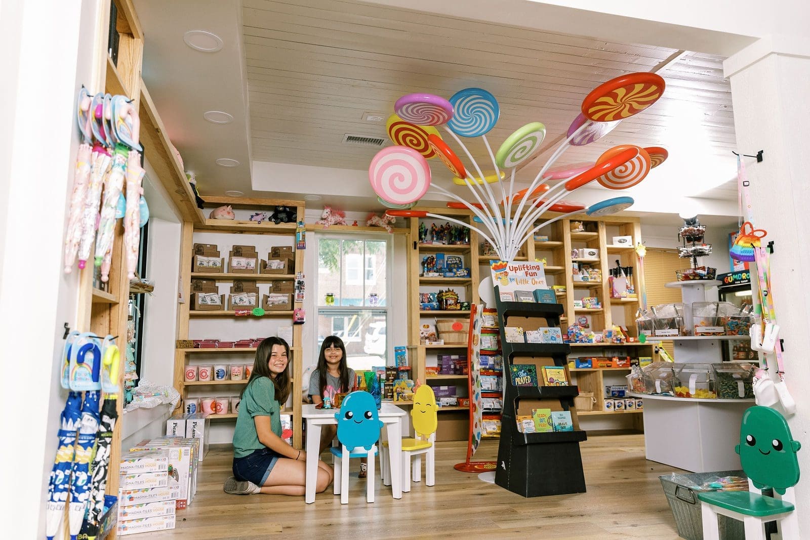 children at a small table surrounded by candy